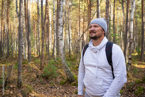 Tourist or traveler with a backpack in the autumn forest. Hiking. 