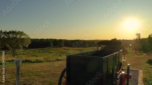 Historic Green and Red wagon on a Hill at sunset near the ocean photo