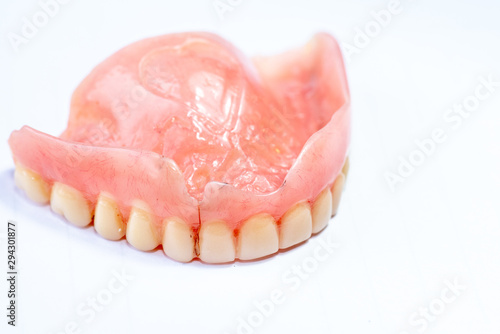 Old denture on a white background.