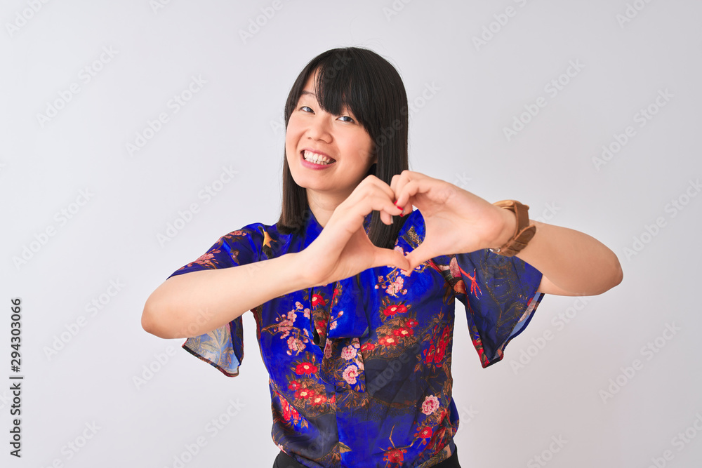 Young beautiful chinese woman wearing summer floral t-shirt over isolated white background smiling in love doing heart symbol shape with hands. Romantic concept. Young beautiful chinese woman wearing summer floral t-shirt over isolated white background smiling in love doing heart symbol shape with hands. Romantic concept.
