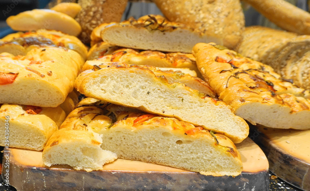 White bread loaf on wooden board close up.