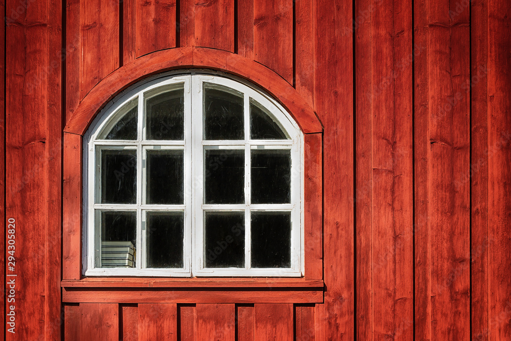 White frame window on a red wall of an old bell tower. White frame window on a red wall of an old bell tower.