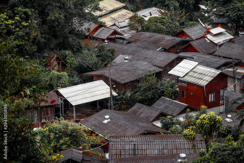 Blurred high angle background of houses roofs, valley dwelling communities, mountains Common living of people and nature, preserving and caring for the ecosystem for future generations Blurred high angle background of houses roofs, valley dwelling communities, mountains Common living of people and nature, preserving and caring for the ecosystem for future generations