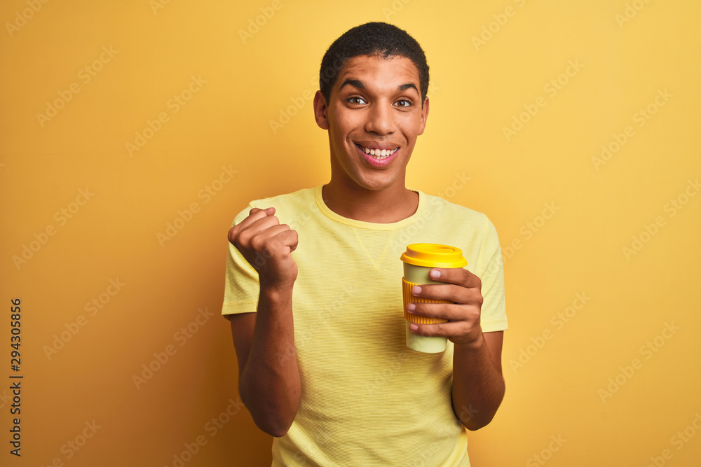 Young handsome arab man drinking take away coffee over isolated yellow background screaming proud and celebrating victory and success very excited, cheering emotion Young handsome arab man drinking take away coffee over isolated yellow background screaming proud and celebrating victory and success very excited, cheering emotion