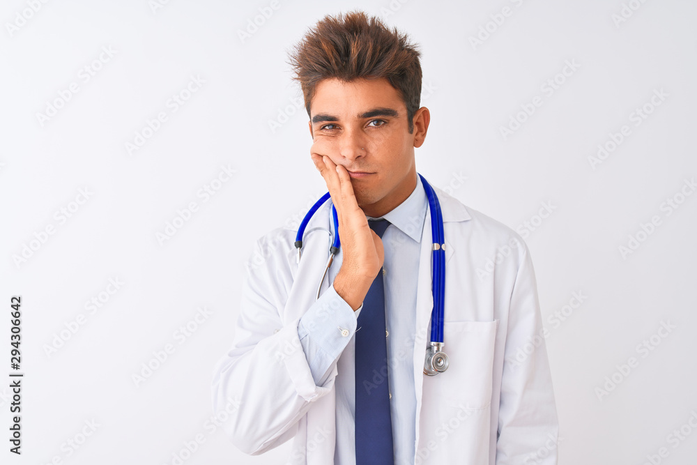 Young handsome doctor man wearing stethoscope over isolated white background thinking looking tired and bored with depression problems with crossed arms. Young handsome doctor man wearing stethoscope over isolated white background thinking looking tired and bored with depression problems with crossed arms.