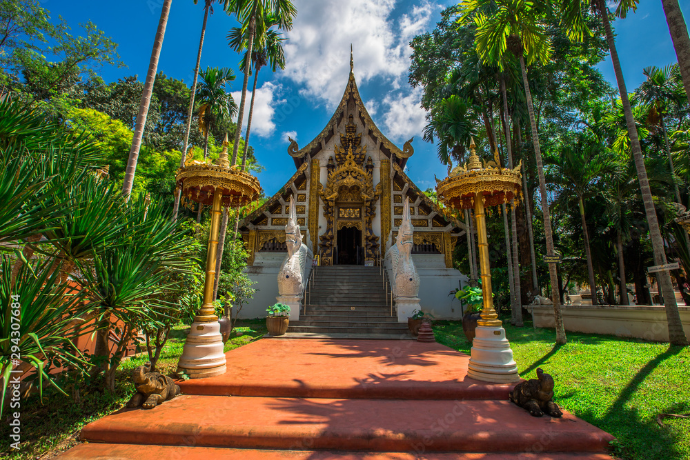 Naklejka premium background,Open view of the temple at Dara Pirom Temple (Mae Rim),which has a large statue in front of the temple. Covered by trees and sky, Chiang Mai Province, Thailand, Wat Pa Daphirom