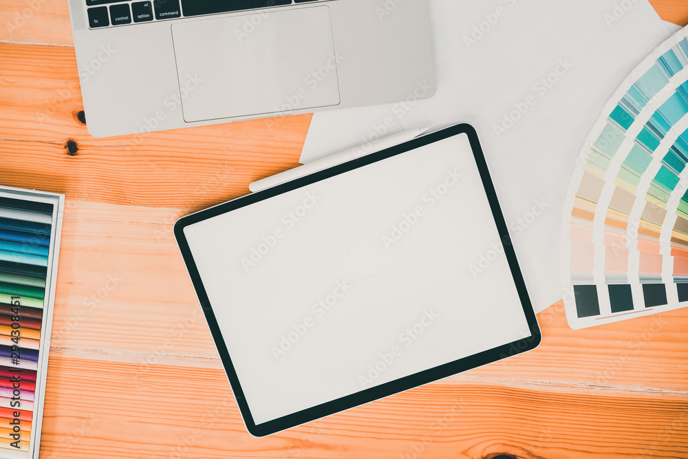 Overhead shot of comfortable graphic design workplace with blank screen mockup tablet on desk background with graphic design accessories. Overhead shot of comfortable graphic design workplace with blank screen mockup tablet on desk background with graphic design accessories.