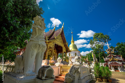 background,Open view of the temple at Dara Pirom Temple (Mae Rim),which has a large statue in front of the temple. Covered by trees and sky, Chiang Mai Province, Thailand, Wat Pa Daphirom photo