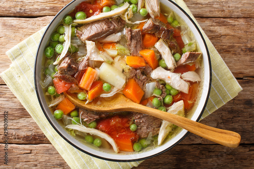 Wisconsin traditional Booyah soup with vegetables and several types of meat close-up in a bowl. Horizontal top view