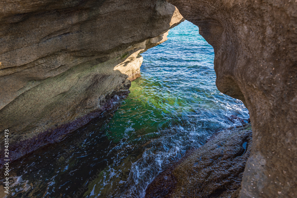 Coastal stone arch with azure clean water