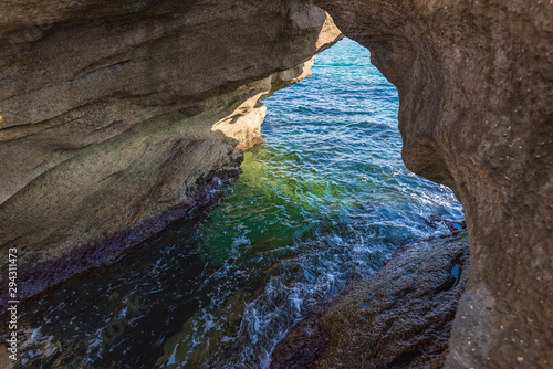 Coastal stone arch with azure clean water