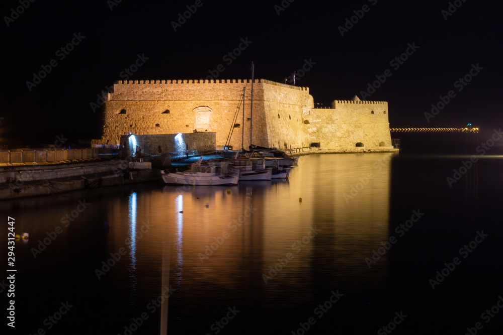 View of old harbour of Heraklion with Venetian Koules Fortress at the  night. Crete, Greece. Heraklion by night. Koule fort at Iraklion, night.  Stock Photo | Adobe Stock
