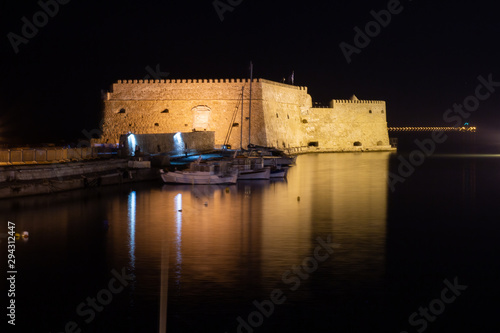View of old harbour of Heraklion with Venetian Koules Fortress at the night. Crete, Greece. Heraklion by night. Koule fort at Iraklion, night.
