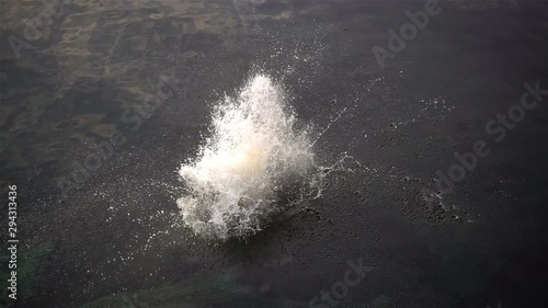 Slow motion splashing water from a man jump into the water.