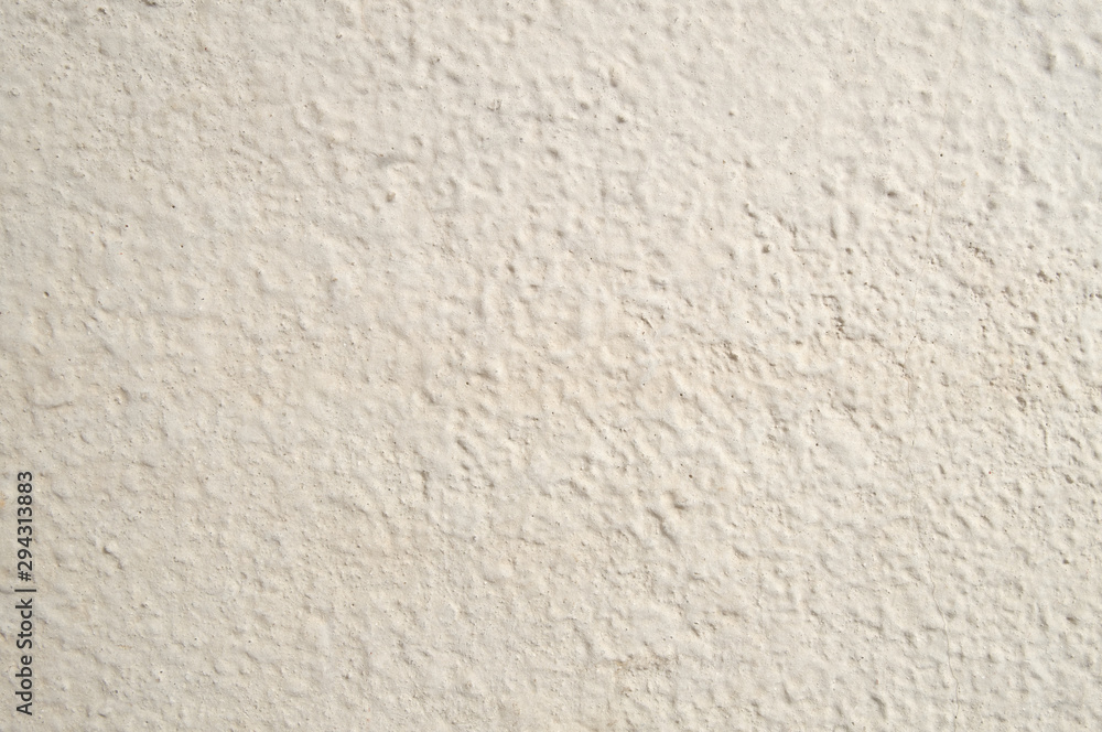 The textural surface of the wall of the house of fashionable color vanilla custard by the sun. The textural surface of the wall of the house of fashionable color vanilla custard by the sun.