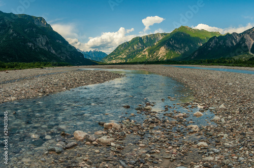 Beautiful alpine landscape with clean cold river in the mountain valley.