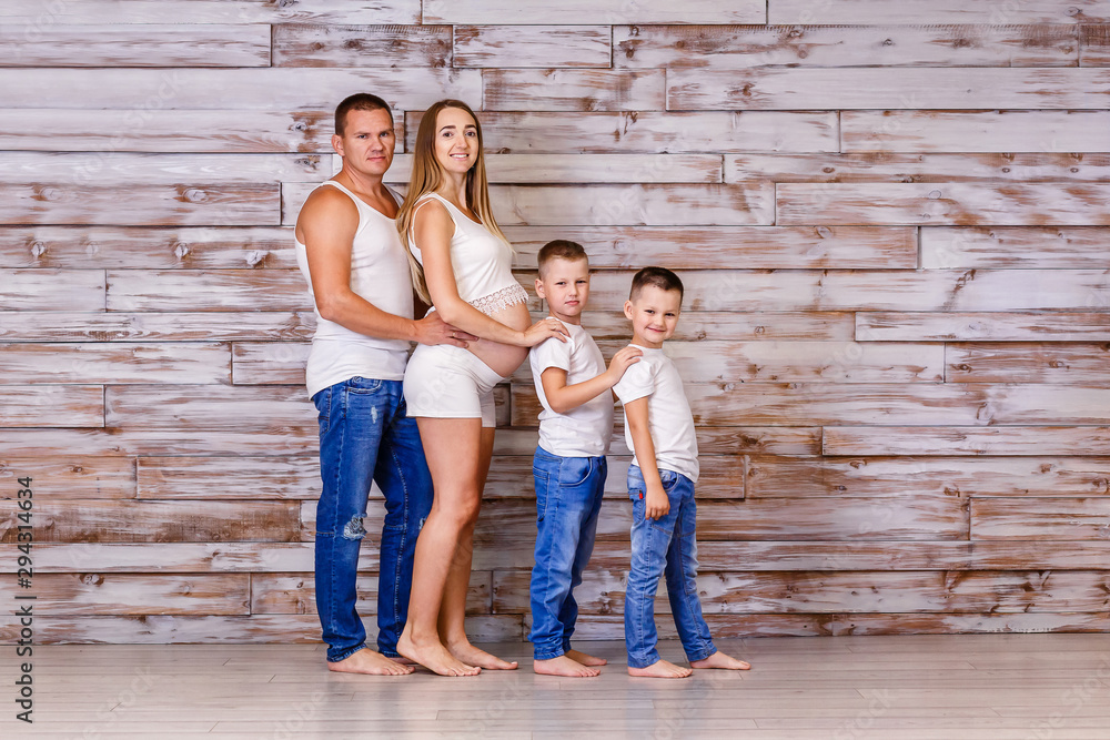 young Caucasian parents and two children indoors young Caucasian parents and two children indoors
