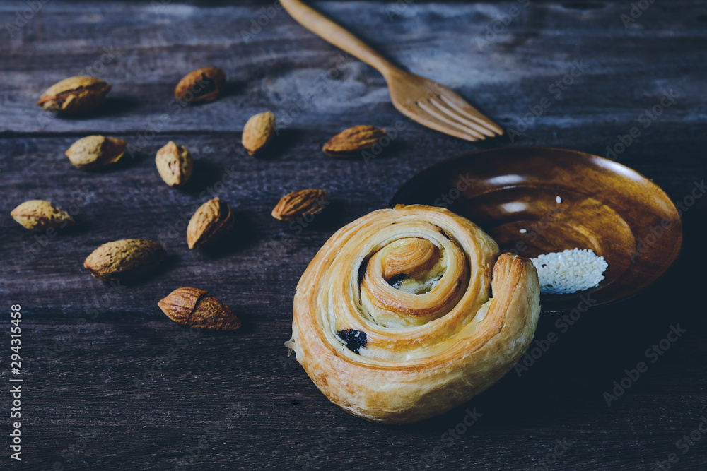 Bread Denis with Chocolate chips with almond on wood background. Bread Denis with Chocolate chips with almond on wood background.
