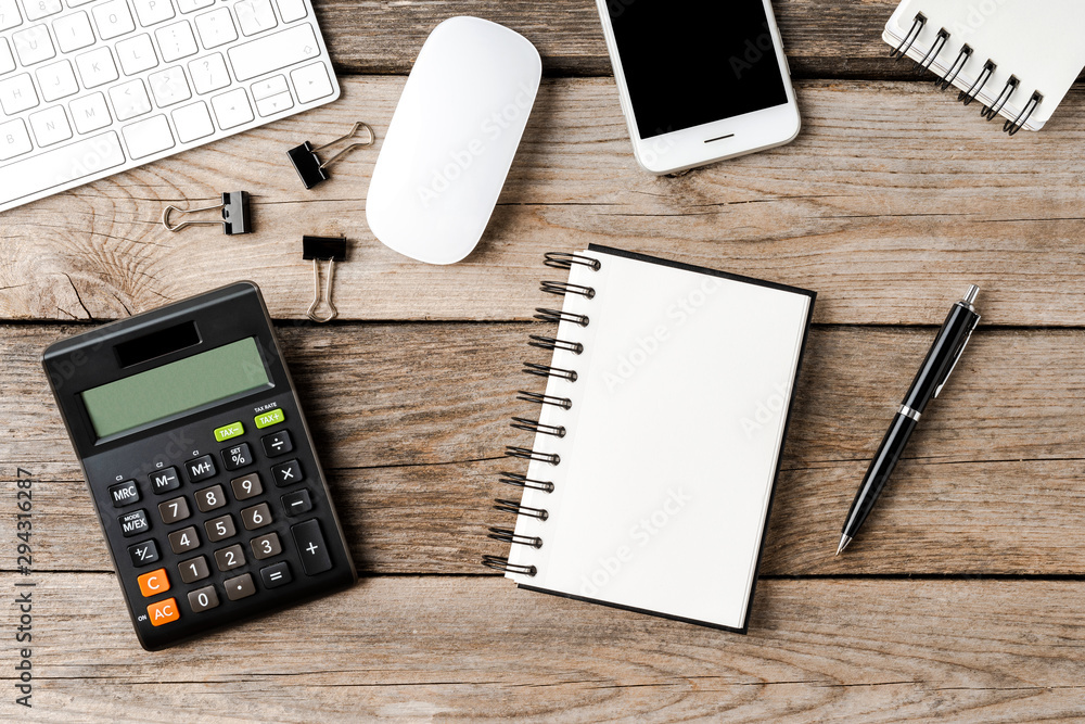 Office desktop with notebook, calculator and accessories. Top view Office desktop with notebook, calculator and accessories. Top view