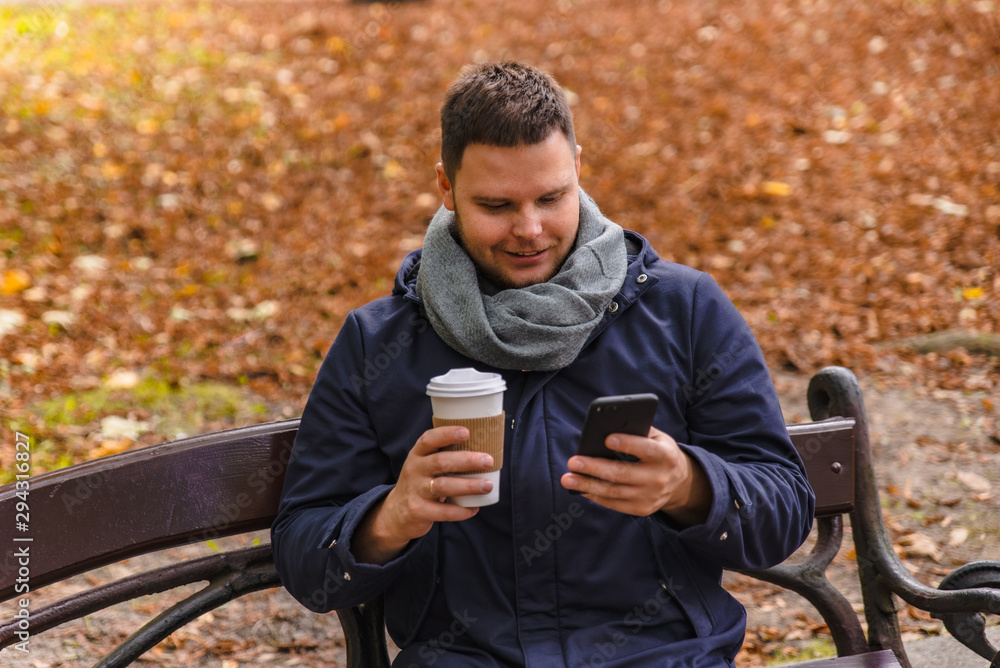 man drinking coffee outdoors autumn season talking on the phone man drinking coffee outdoors autumn season talking on the phone