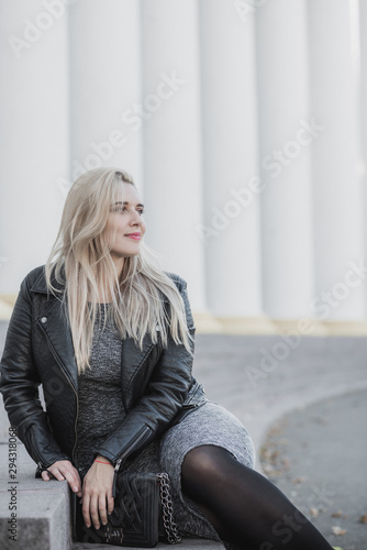 Happy woman of plus size, American or European appearance enjoying life. Young lady with excess weight, stylishly dressed at city styeet.Natural beauty 