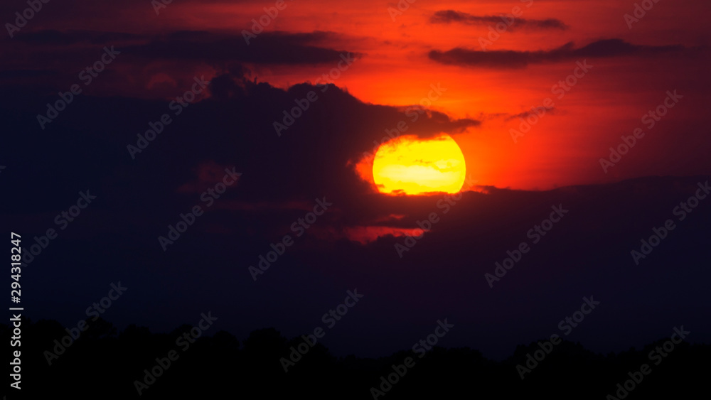 A scenic view of a setting sun. A scenic view of a setting sun.