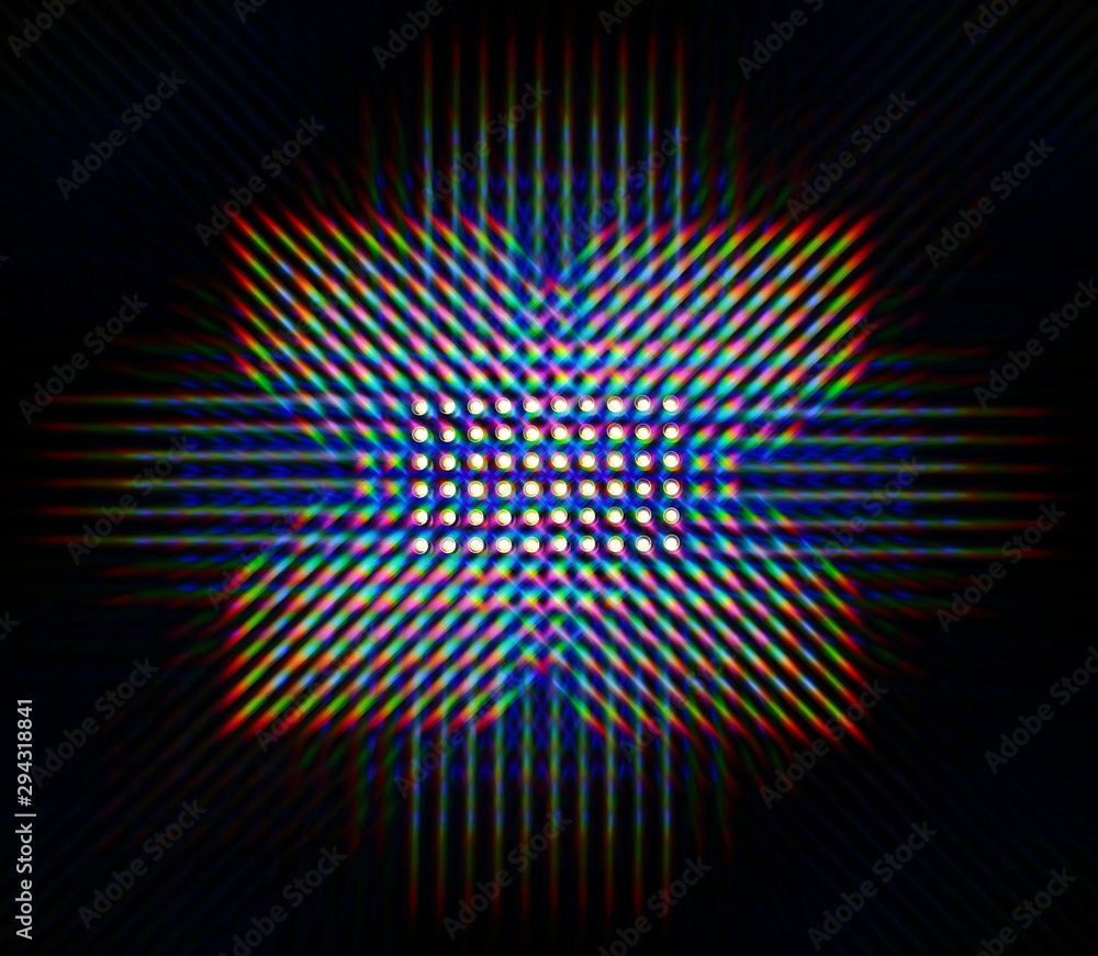 Photo of the diffraction pattern of LED array light, comprising a large number of diffraction orders obtained by the thin phase gratings Photo of the diffraction pattern of LED array light, comprising a large number of diffraction orders obtained by the thin phase gratings
