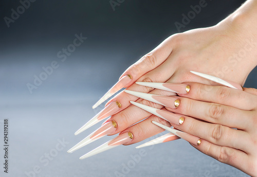 Fototapeta Piękne długie paznokcie kobiety. Białe długie paznokcie. Specjalna umiejętność manicure.
