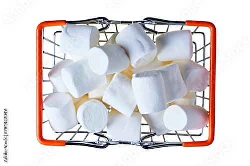 Metal market basket with orange rubber handles full of many pieces of raw sweet tasty marshmallows cylindrical form isolated on white background. Top view