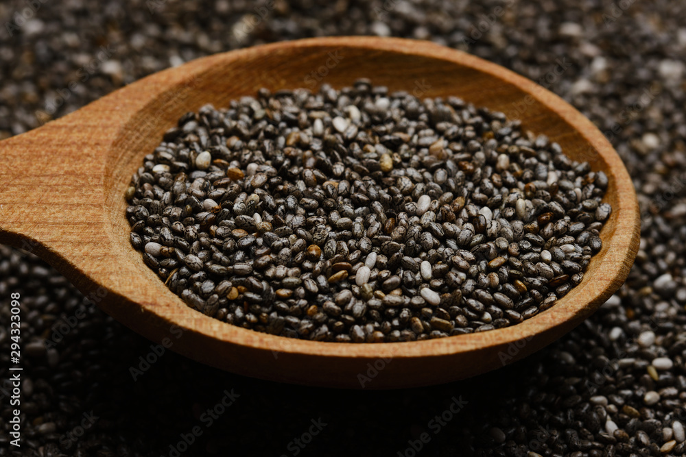 chia seeds in wooden spoon. chia seeds background chia seeds in wooden spoon. chia seeds background