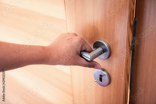Woman Hand is Holding Door Knob While Opening a Door in Bedroom, Lock Security System and Access Safety of Doorway., Interior Design of Doorknob Entering to Accessibility Private Room