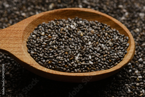chia seeds in wooden spoon. chia seeds background