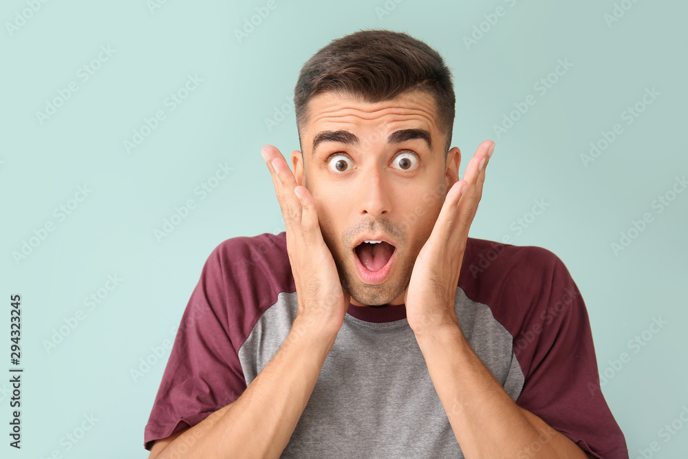 Surprised young man on color background Surprised young man on color background