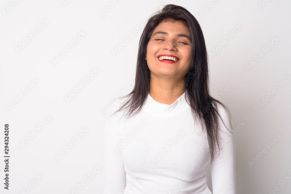 Happy young beautiful Persian woman relaxing with eyes closed Happy young beautiful Persian woman relaxing with eyes closed