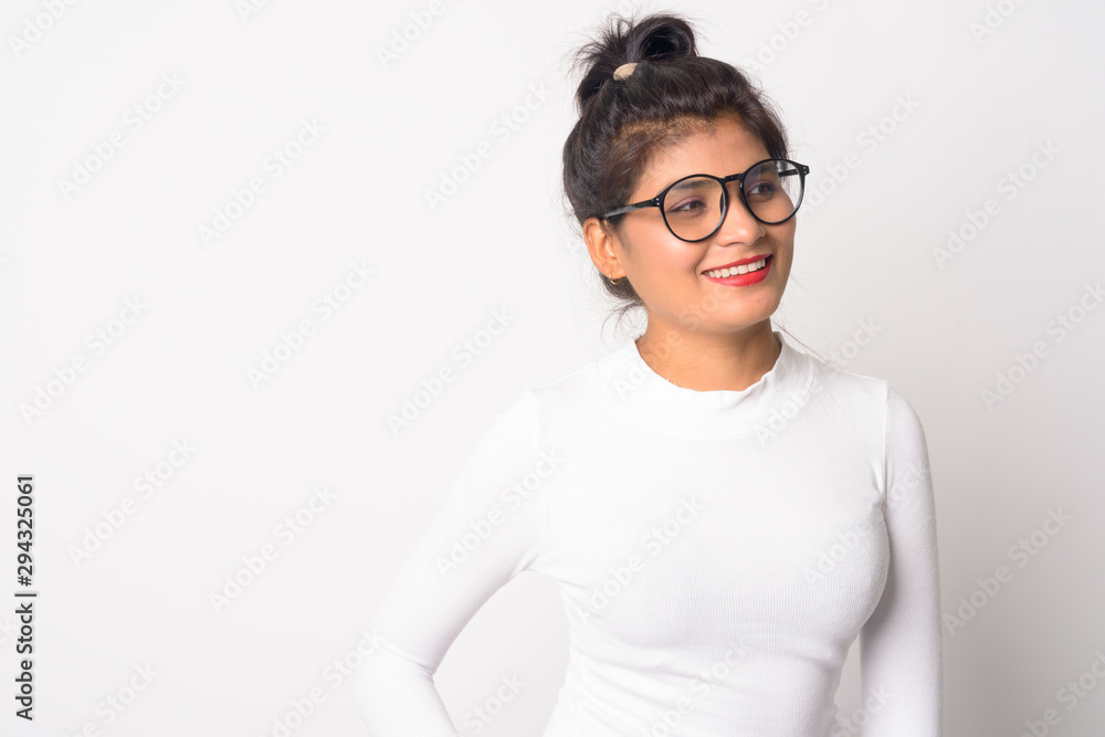 Happy young beautiful Persian woman with eyeglasses thinking