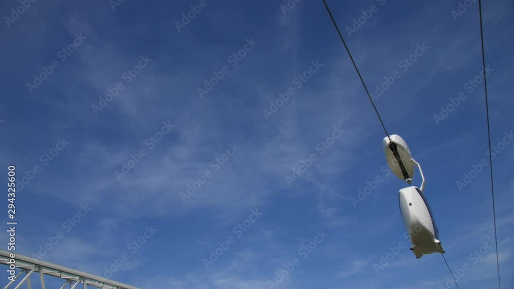 skyway uniwind moves along cableway against blue sky skyway uniwind moves along cableway against blue sky