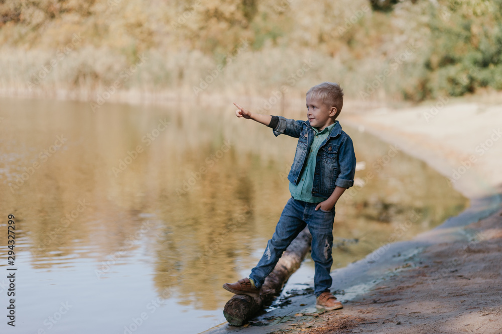Portrait of cute smiling boy on a summer riverbank. Portrait of cute smiling boy on a summer riverbank.