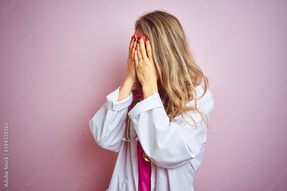 Young beautiful doctor woman using stethoscope over pink isolated background with sad expression covering face with hands while crying. Depression concept. Young beautiful doctor woman using stethoscope over pink isolated background with sad expression covering face with hands while crying. Depression concept.