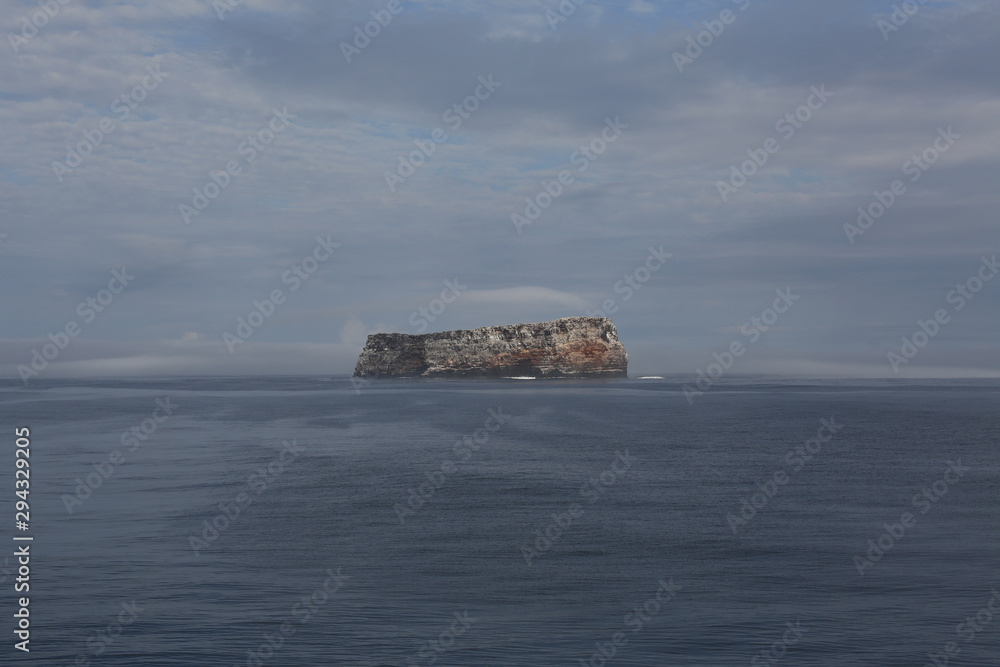 ship and island in the fog, Galapagos, Pacific Ocean