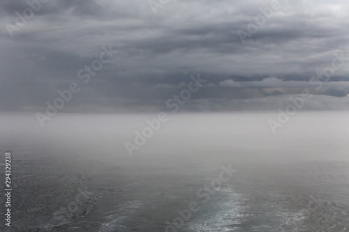 ship and island in the fog, Galapagos, Pacific Ocean