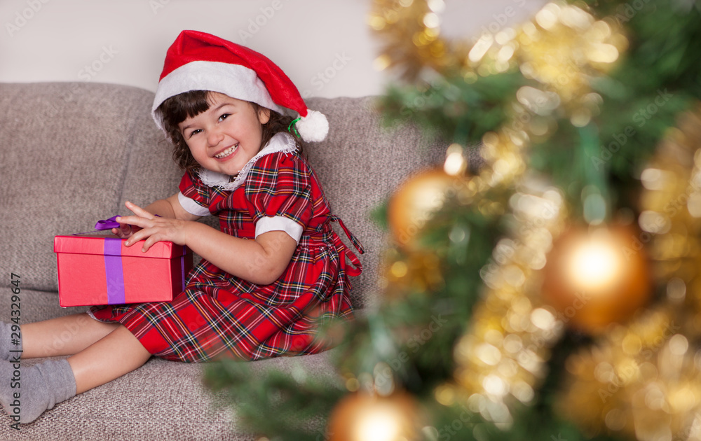 Cute child opens a christmas present Cute child opens a christmas present