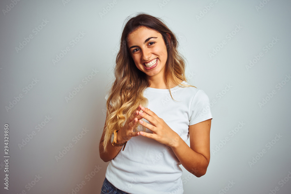 Young beautiful woman wearing casual white t-shirt over isolated background Hands together and fingers crossed smiling relaxed and cheerful. Success and optimistic Young beautiful woman wearing casual white t-shirt over isolated background Hands together and fingers crossed smiling relaxed and cheerful. Success and optimistic