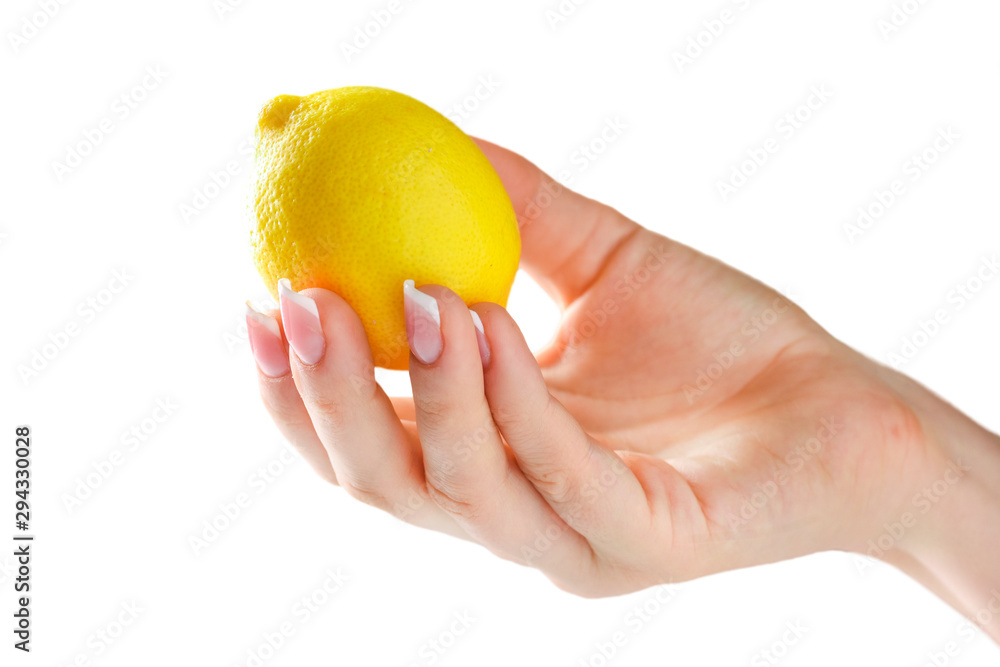 Lemon in woman hand isolated. Woman holding lemon in her fingers with beautiful nails on white background. Lemon in woman hand isolated. Woman holding lemon in her fingers with beautiful nails on white background.