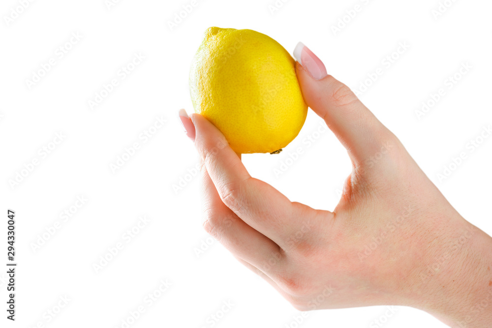 Lemon in woman hand isolated. Woman holding lemon in her fingers with beautiful nails on white background. Lemon in woman hand isolated. Woman holding lemon in her fingers with beautiful nails on white background.