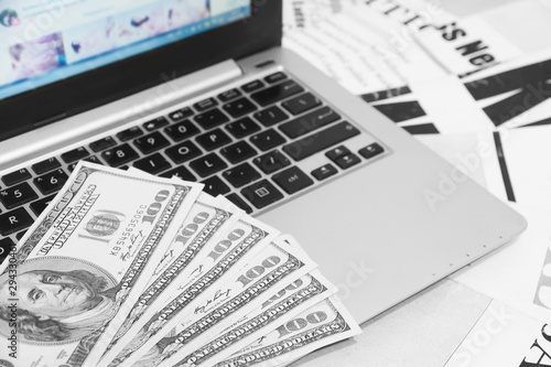 Newspapers, Laptop and Money in Cash. Business Magazines and Computer as Concept for Finance and Banking. Internet Technology for Media and News 