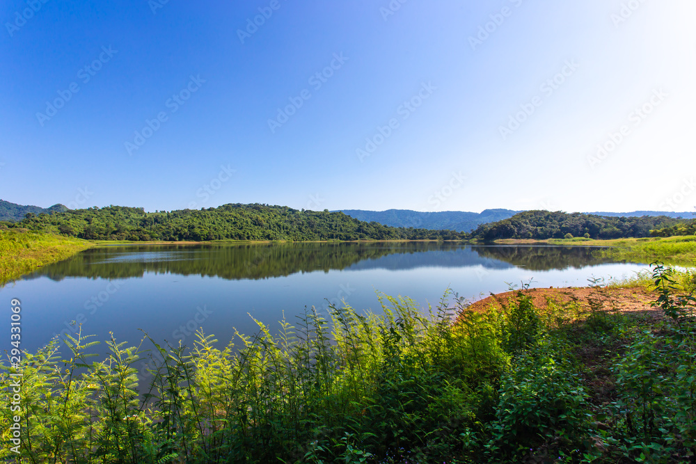 Beautiful landscape view of mountains and trees at reservoir in Thailan Beautiful landscape view of mountains and trees at reservoir in Thailan