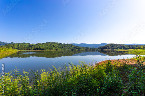 Beautiful landscape view of mountains and trees at reservoir in Thailan