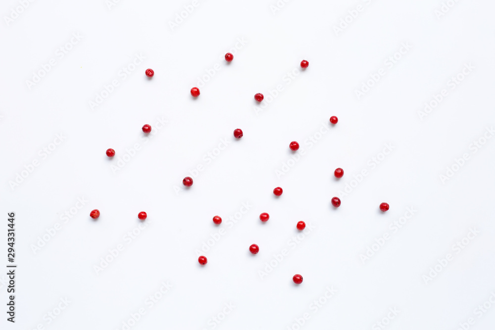 Red peppercorns  on white