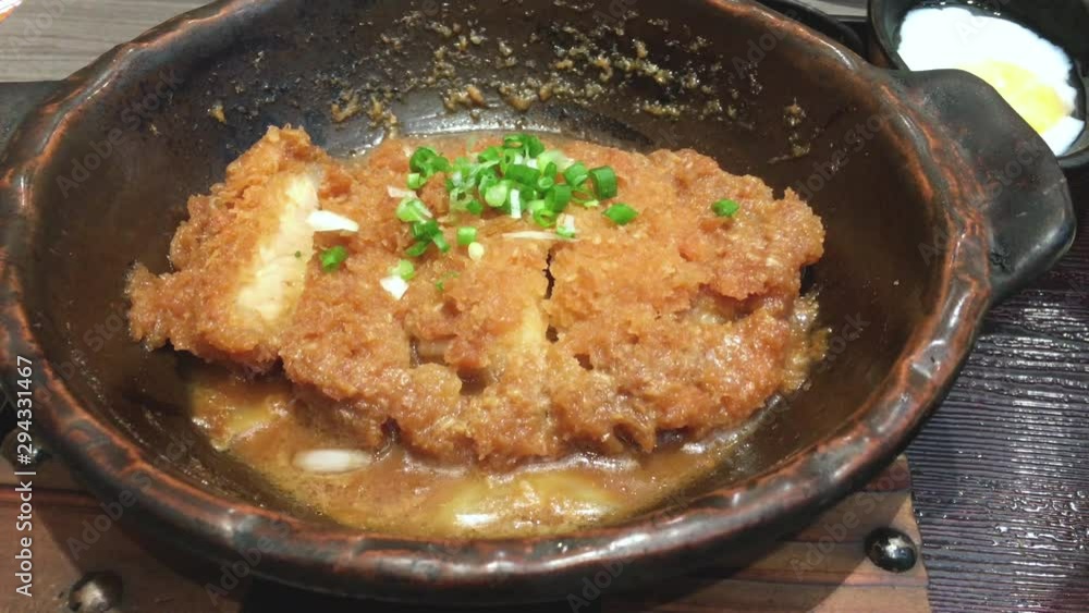 Crispy fried pork or Tonkatsu with miso sauce in the bowl. Japanese food. Crispy fried pork or Tonkatsu with miso sauce in the bowl. Japanese food.