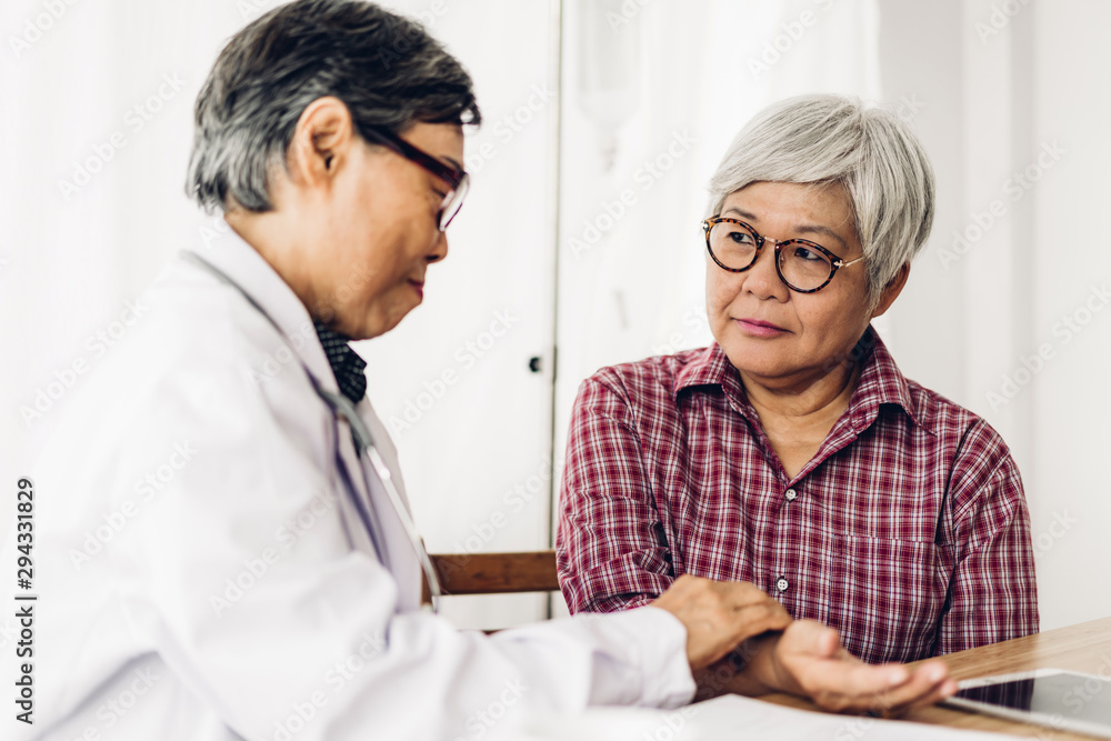 Doctor consulting and check up information with senior woman in hospital.elderly woman has sick.healthcare and medicine Doctor consulting and check up information with senior woman in hospital.elderly woman has sick.healthcare and medicine
